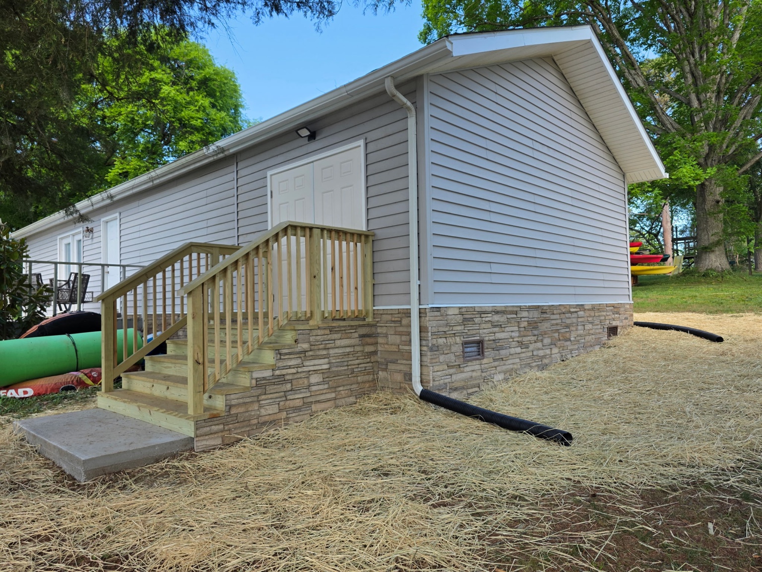 Storage addition with stairs and small deck