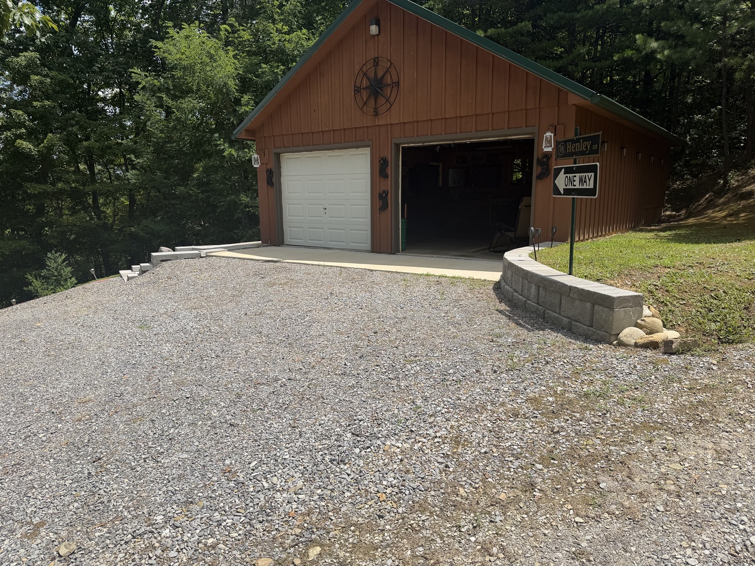 Gravel parking area, concrete apron, and retaining wall